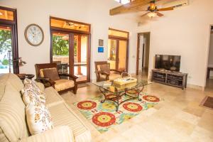 a living room with a couch and a tv at Chula Vista Home in West Bay