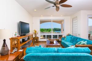 a living room with blue couches and a flat screen tv at Coral Vista #3 Home in West End