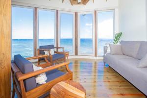 a living room with a view of the ocean at Stunning views at - Villa Aire apts in Roatan