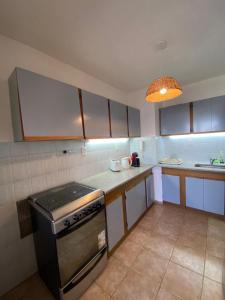 a kitchen with a stove and a counter top at Apartamento Rufina VII pleno centro San Luis in San Luis