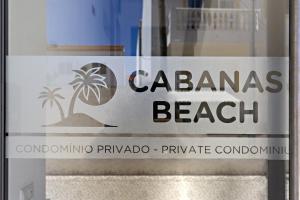 a sign for a beach on a glass door at Ocean Breeze Apartment in Cabanas de Tavira