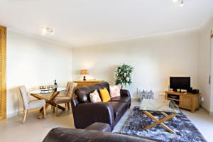 a living room with a couch and a table at Ocean Breeze Apartment in Cabanas de Tavira