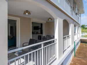 a balcony of a house with chairs on it at Le Paradis Bleu in Les Trois-Îlets