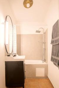 a bathroom with a sink and a shower and a tub at Rare Appart 2 chambres en duplex design au Panier in Marseille