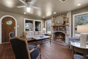 a living room with a couch and a fireplace at Milk Bath Springs House in Dripping Springs