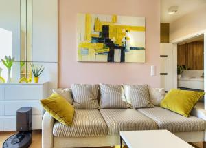 a living room with a couch and a painting at Apartament enjoy! Gdańsk Old Town in Gdańsk