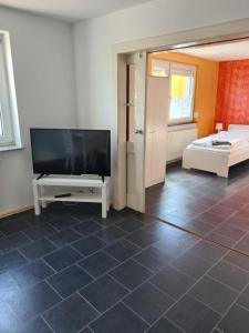 a living room with a flat screen tv and a couch at Wölfersheim-Berstadt in Wölfersheim