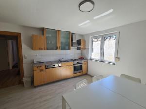 a kitchen with wooden cabinets and a table and a window at Wölfersheim-Berstadt in Wölfersheim