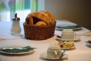 a basket of bread sitting on top of a table at Hotel Arlette Beim Hauptbahnhof in Zurich