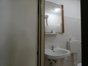 a bathroom with a sink and a mirror at Rose Village Guest House in Rome