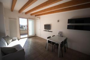 a living room with a couch and a table at Bertoldi Terme sul Garda - Terrazza in Nago-Torbole +20 photos