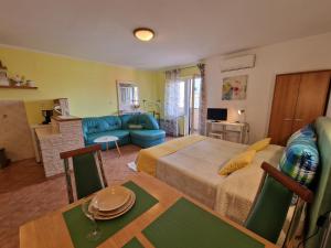 a living room with a bed and a dining room at Apartments Rina in Rovinj