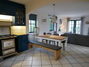 a kitchen with a table and a bench in it at Villa Buiten 108 in Callantsoog