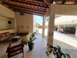 a living room with a couch and a table at Pousada Águas Douradas in Aracaju