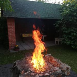 a fire pit in a yard with flames at SeeYou Apartman Agárd in Agárd