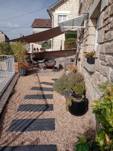 a backyard with a patio with a deck at Le 28 in Uzerche