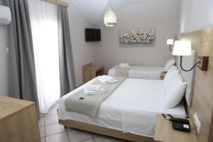 Letto o letti in una camera di Caretta - Caretta Hotel