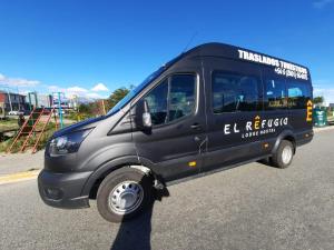 a black van parked on the side of the road at El Refugio Lodge Hostel in Ushuaia