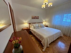 Un dormitorio con una cama y una mesa con flores. en Villa HOPE, en Zmijavci