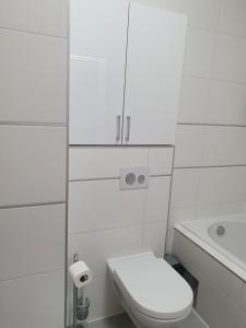 a white bathroom with a toilet and a sink at Apartment I Love Zagreb, free private parking in Zagreb