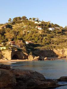 a view of a beach with houses on a hill at Giota & Antonia Apartments in Koroni