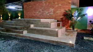 a set of concrete steps in front of a brick wall at Gbsitio in Brasilia
