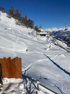 a snow covered hill with tracks in the snow at Chalet , Thyon Les Collons, 4 Vallées in Les Collons