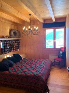 a bedroom with a bed and a chandelier at Chalet , Thyon Les Collons, 4 Vallées in Les Collons