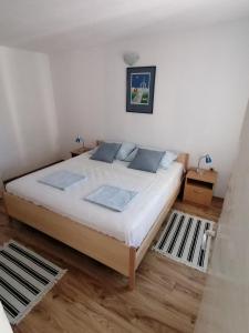 a bedroom with a large bed in a room at Apartman Nora in Hvar