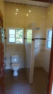 a bathroom with a toilet and a shower at Khao Sok Jasmine Garden Resort - SHA Certified in Khao Sok National Park
