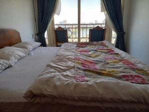 A bed or beds in a room at Nile House