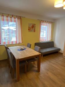 a living room with a table and a couch at Landhaus Julian in Neustift im Stubaital