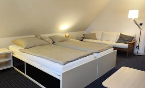 a room with a large bed and a couch at Komfort-Ferienwohnung "Zur Schmiedebrücke" in Großschönau