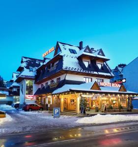 a large building with snow on the roof at Willa Monte Rosa in Zakopane