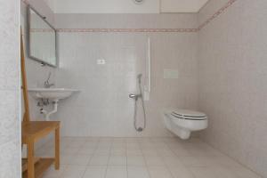 a bathroom with a toilet, sink, and bathtub at Affittacamere Le Giare in Riomaggiore