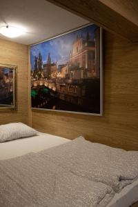 a bedroom with a large painting on the wall at Hostel 24 in Ljubljana