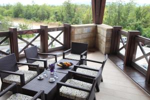 a patio with a table and chairs on a balcony at Hotel Danubia Park in Veliko Gradište