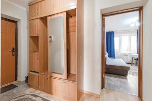 a room with a mirror and a bedroom with a bed at Уютная квартира in Astana