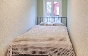 a bed in a room with a window at Amazing Home In Hidrasund With Wifi in Eide +3 photos