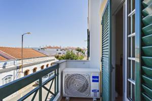 a room with a air conditioner on a balcony at Cabanas Vintage Apartment in Tavira +3 photos