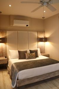 a bedroom with a large bed and two lamps at Matisia Hotel Boutique in Guaduas