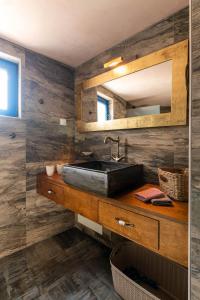 a bathroom with a sink and a mirror at Aspasia's House in Zákros