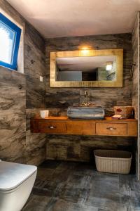 a bathroom with a sink and a mirror at Aspasia's House in Zákros