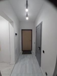 an empty room with a door and a hallway at Sezim Qala 10 in Taldykolʼ