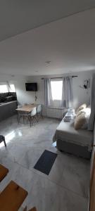 a bedroom with a bed and a table in a room at VERA Apart in El Chalten