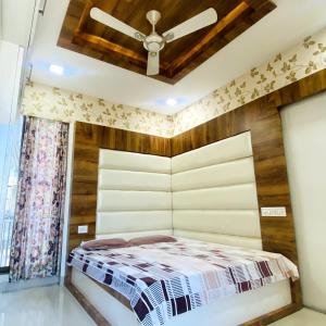 a bedroom with a bed and a ceiling fan at Sunspot -Entire Villa Apartment in Ujjain