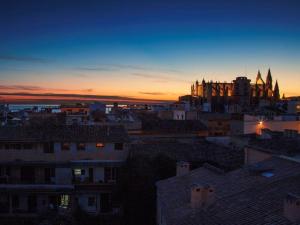 a view of a city at sunset with a cathedral at Sant Francesc Hotel Singular in Palma de Mallorca