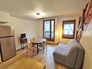 a living room with a couch and a table at Rêves de montagne, T2 bis, Luchon, wifi, parking gratuit, 4 personnes in Luchon