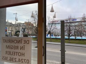 a sign in the window of a bus stop at Sweet cozy Ultracentral in Craiova