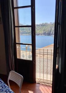 a room with a view of a beach from a window at Sea View Apartment in Capraia